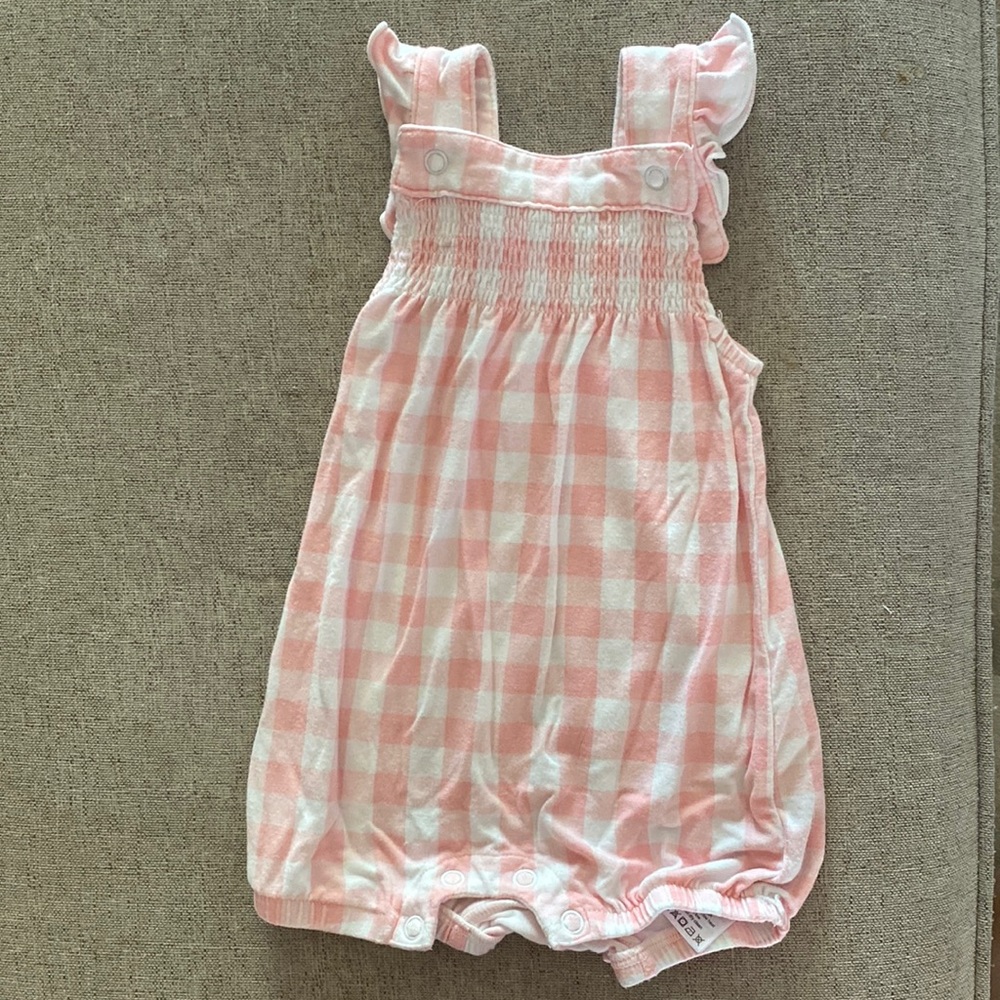 Smocked front overall shortie in pink.